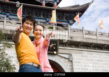 Young Couple Pointing at Camera, Dali Stock Photo