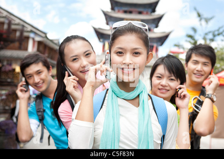 Young adults using cellphones Stock Photo