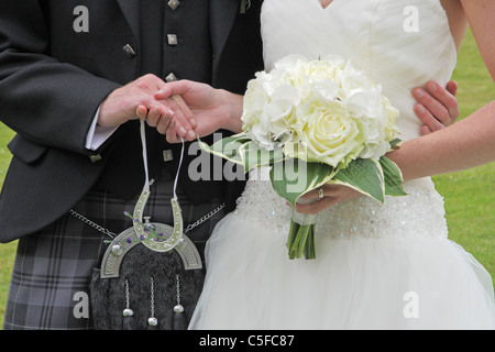 Newly married couple at wedding holding hands. Stock Photo