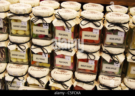 Jars of sweets in shop Stock Photo