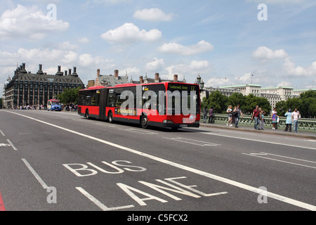 A bendy bus traveling across Westminster Bridge