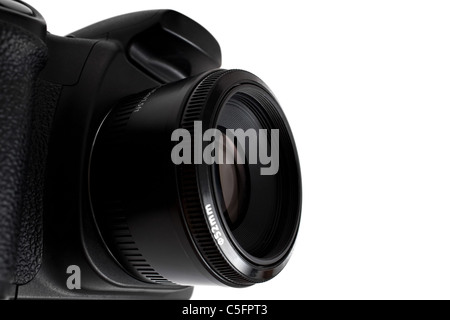 Black generic digital DSLR camera and attached lens isolated over white as seen from a dramatic angle. Shallow depth of field. Stock Photo