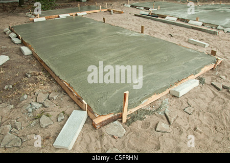 Freshly poured concrete slab and sand Stock Photo