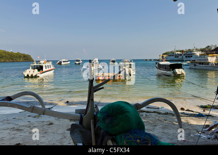 BALI, INDONESIA - NOV 12 2010: Boats moored Padang Bai Harbour in Bali, a popular cruise ship destination. Stock Photo