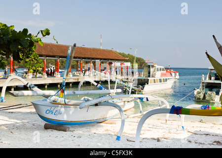 BALI, INDONESIA - NOV 12 2010: Tradition fishing boat at in Bali with passenger ship wharf in background, Stock Photo