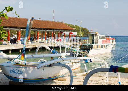 BALI, INDONESIA - NOV 12 2010: Outrigger fishing boat at Padang Bai Harbour in Bali, a popular cruise ship destination. Stock Photo