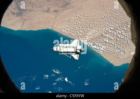 Space shuttle Discovery as seen from the International Space Station above southwestern coast of Morocco March 7 2011 Stock Photo