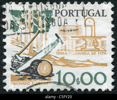 PORTUGAL - 1979: A stamp printed in the Portugal, is depicted tool woodcutter, two-handled saw and ax Stock Photo