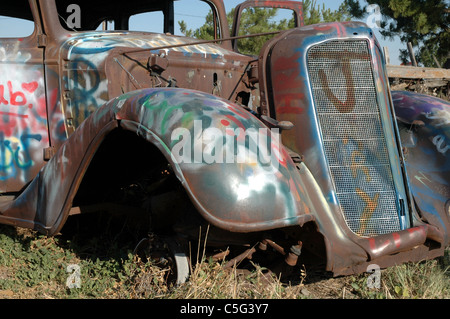 The front of a 1933 Ford Coupe is a target for vandalism from people who drive past. The car sits along route 66 near Amarillo. Stock Photo