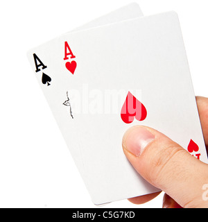 Ace of hearts and clubs in a hand against a white background Stock Photo