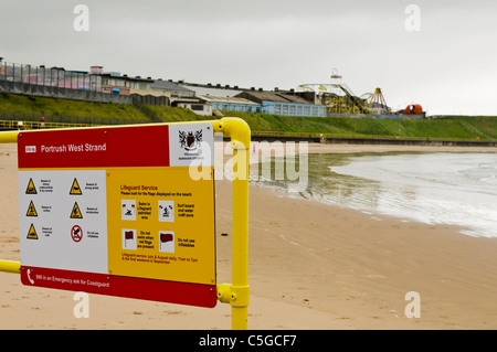 Sign at Portrush West Strand warning people of the dangers when swimming Stock Photo