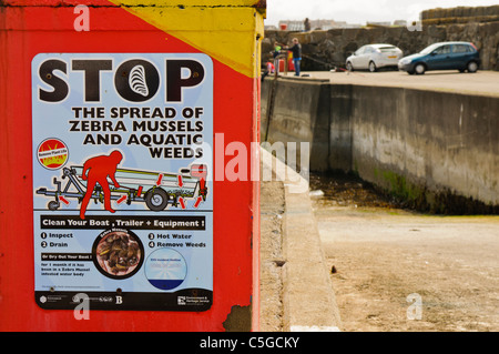 Sign on a harbour slipway warning people of the spread of Zebra mussels Stock Photo