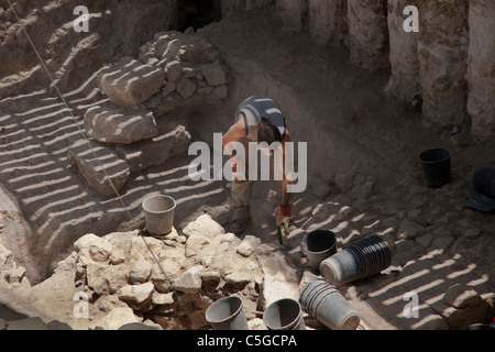 An archeologist digging in Ir David or City of David a major archaeological site near the Temple mount in East Jerusalem which is speculated to compose the original urban core of ancient Jerusalem. Israel on 07 March 2016 After nine years of excavating by the Israel Antiquities Authority, archaeologists at the City of David National Park succeeded in reaching the strata of ancient Jerusalem dating to the First Temple period. Stock Photo