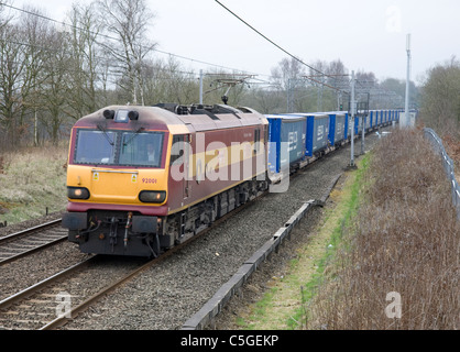 Electric locomotive hauling a freight train, northbound, through Standish, on the West Coast mainline. Stock Photo