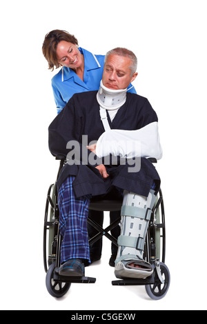 Photo of an injured man in a wheelchair with a female nurse pushing him, isolated on a white background. Stock Photo