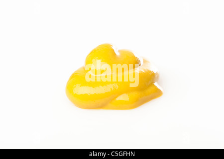 A yellow squirt of mustard against a white background Stock Photo