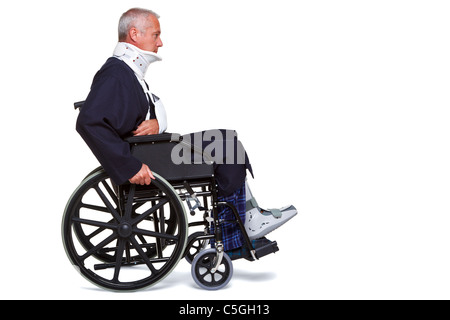 Photo of an injured man pushing himself along in his wheelchair, isolated on a white background. Stock Photo