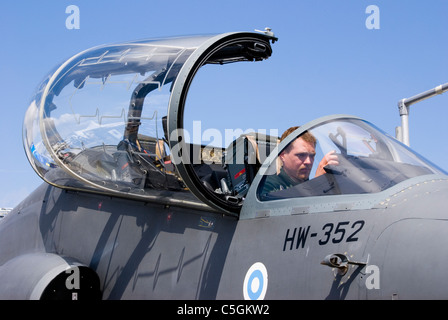 Military fighter aircraft with pilot seated in cockpit Stock Photo