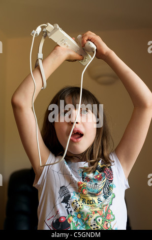 Young girl playing with a Nintendo Wii games machine Stock Photo - Alamy