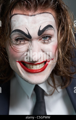 Portrait of dramatist with painted face grimacing at camera Stock Photo