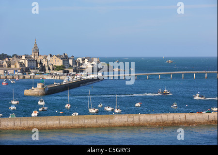 The church Notre-Dame de Croaz Batz and sailing boats and fishing boats in the harbour of Roscoff, Finistère, Brittany, France Stock Photo