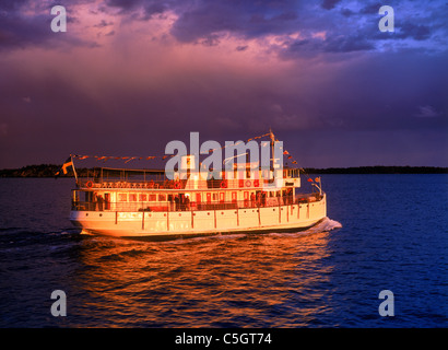 Gota Canal boat crossing part of Baltic Sea off Sweden's East Coast under dramatic summer rain clouds Stock Photo