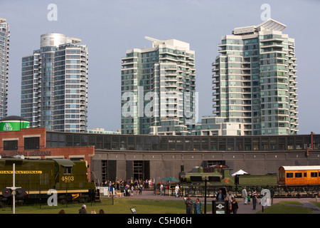 the Toronto Railway Heritage Centre in Roundhouse Park with queens quay apartment blocks in the background toronto ontario Stock Photo
