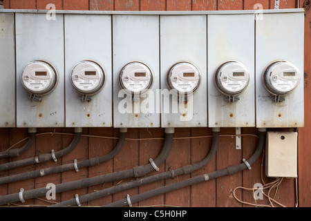 row of electricity meters on the side of an apartment block split house in toronto ontario canada Stock Photo