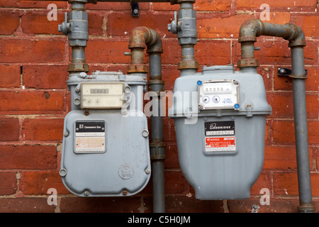 old household gas meters on the outside wall of a split house in toronto ontario canada Stock Photo