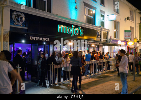 people gathered outside Mojo's nightclub and bar in Norwich, UK Stock Photo