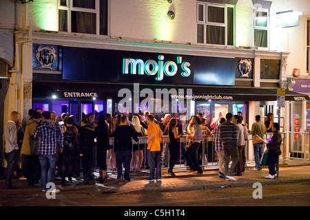 people gathered outside Mojo's nightclub and bar in Norwich, UK Stock Photo