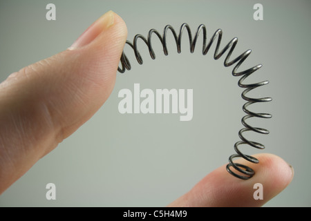 Bending Spring Between Fingers Stock Photo - Alamy