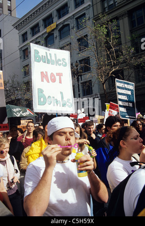 marcher in anti iraq war protest march has sign bubbles not bombs as he blows bubbles circa 2004 Stock Photo