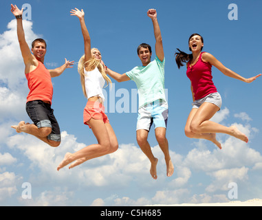 Portrait of four jumping happy people Stock Photo