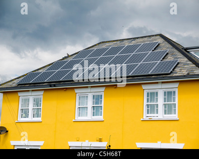 Large array of Photovoltaic solar panels on the roof of a house in Aldeburgh Suffolk Stock Photo