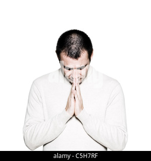 Portrait of a handsome expressive religious man praying in studio on white isolated background Stock Photo