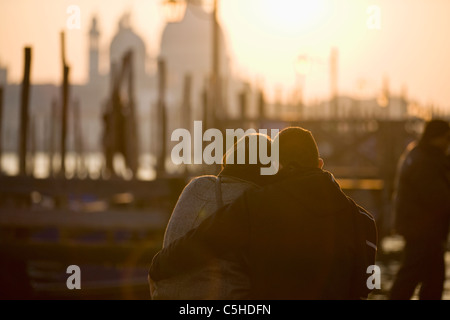 A couple watching the sunset over Santa Maria della Salute, Venice, Italy  Venice, Italy Stock Photo