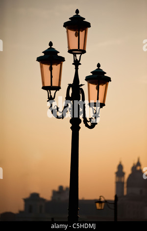 An ornate street lamp at sunset, Venice, Italy Stock Photo