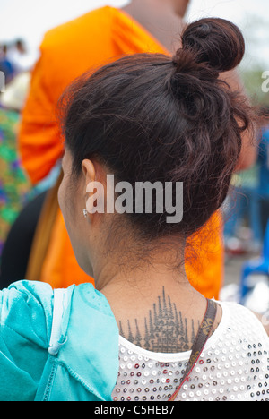 A woman with Sak Yant, the sacred tattoo, on her back Stock Photo