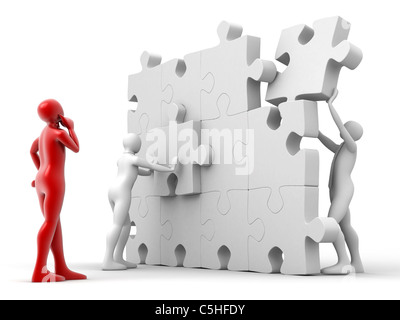 Men putting puzzle pieces together Stock Photo