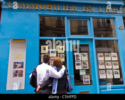 Paris, France, Couple, Rear, Shop Window Displays, Shopping at Real Estate Agent, in the Ile Saint Louis 'L'Immobilier en L'Ile' Store Front, property investing market, looking estate agent window, city colour Stock Photo