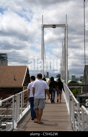 people walking over pedestrian bridge in harbourfront marina toronto ontario canada