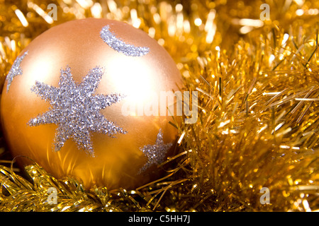 Christmas bauble with gold star on gold Christmas chain Stock Photo