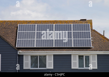 Twelve photovoltaic solar panels on an energy efficient eco home house roof residential domestic property. West Sussex, England, UK, Britain Stock Photo