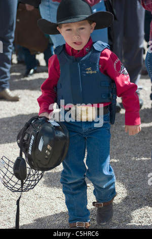 Young cowboys prep in protective gear for kid's mutton busting at the rodeo in Tucson Arizona Stock Photo
