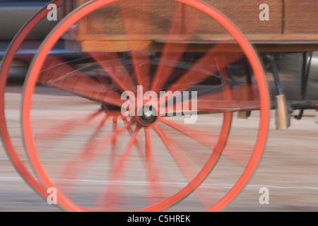 Antique wagon wheels turning during preparation for Tucson rodeo parade in Tucson, Arizona Stock Photo