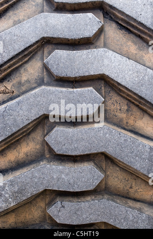 Rubber tire tread texture of a tractor or other heavy duty construction machinery. Stock Photo