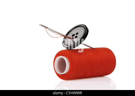A roll of black thread and a needle on a piece of blue jeans denim Stock  Photo - Alamy