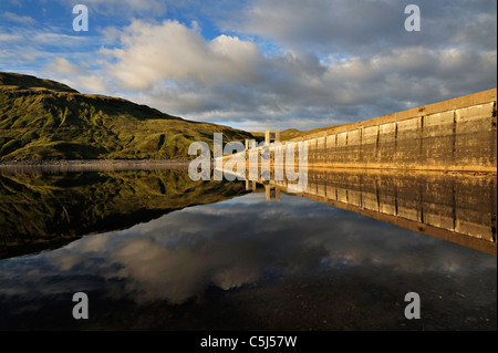 Hydro-electric dam and reservoir in Glen Lyon with pebbled shore and distant ridgeline, Glen Lyon, Perthshire, Scotland, UK. Stock Photo