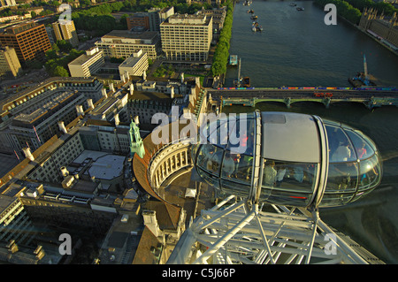 From-above view of a section of the main wheel and a passenger cabin on the London Eye with the roofs of County Hall and the Stock Photo